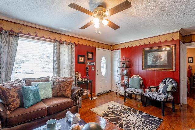 living room featuring plenty of natural light, ceiling fan, crown molding, and hardwood / wood-style flooring