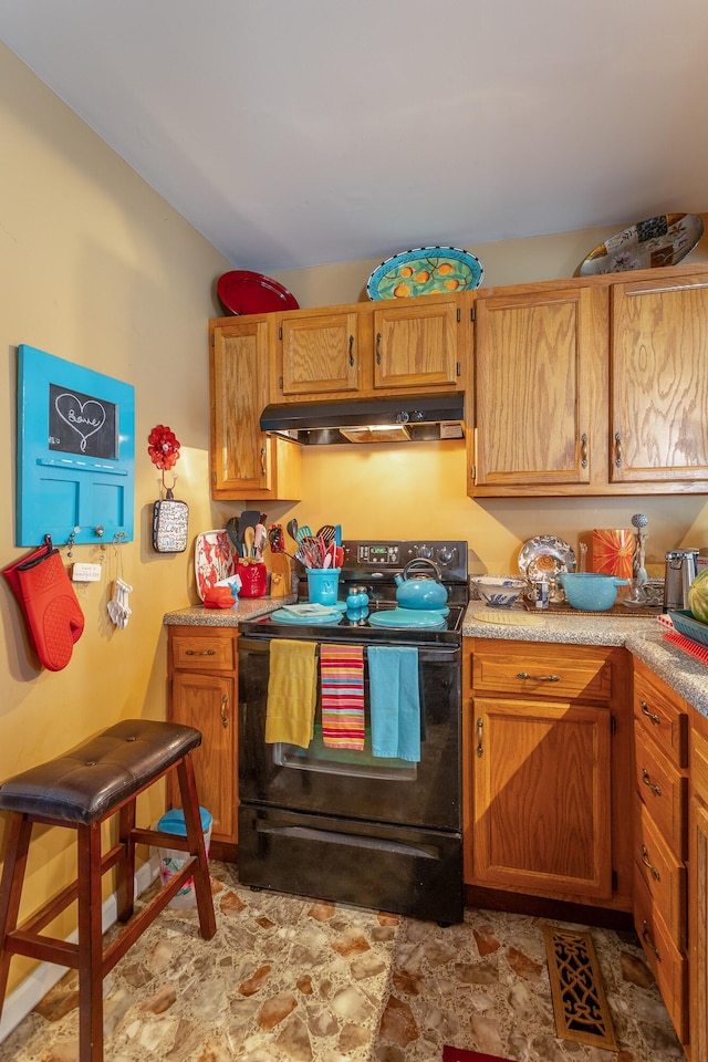 kitchen featuring light tile patterned floors, electric range, and premium range hood