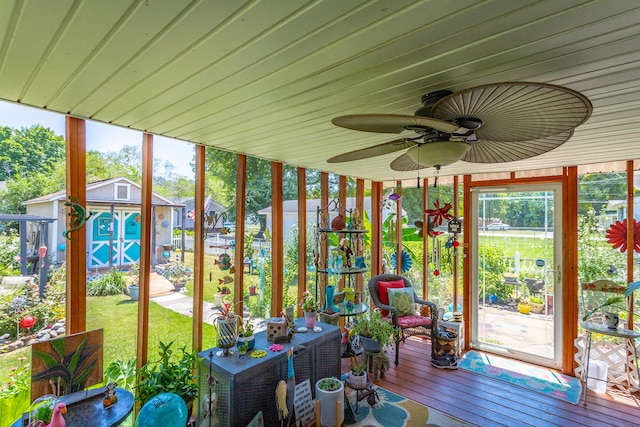 unfurnished sunroom with ceiling fan