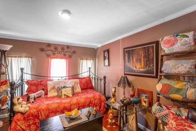 bedroom featuring hardwood / wood-style floors and ornamental molding