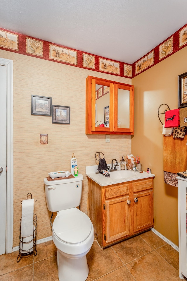 bathroom featuring toilet, vanity, and tile patterned floors