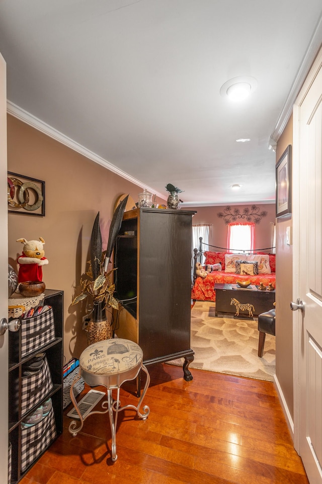 hall with crown molding and wood-type flooring