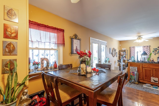 dining space with a wealth of natural light, ceiling fan, french doors, and wood-type flooring