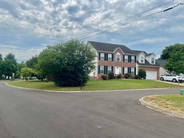 view of front of property with a front yard and a garage