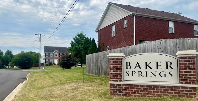 community sign featuring a lawn