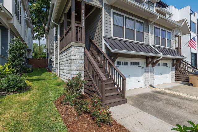 view of front of house featuring cooling unit, a garage, and a front yard