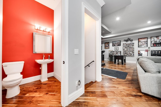 hall featuring recessed lighting, baseboards, an upstairs landing, and wood finished floors