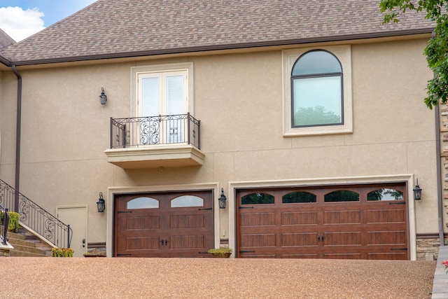 view of front of house with a balcony and a garage