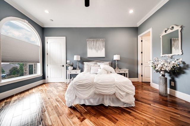 bedroom featuring hardwood / wood-style floors and crown molding