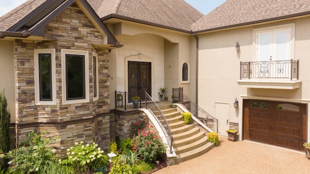 property entrance featuring a balcony and a garage