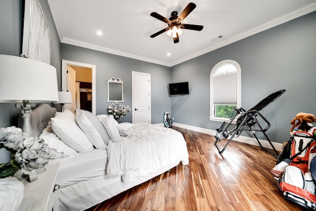 bedroom with ceiling fan, hardwood / wood-style floors, and crown molding