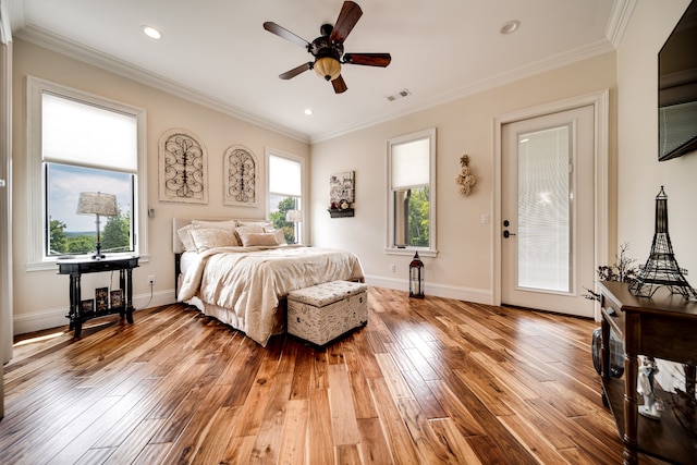 bedroom with multiple windows, ornamental molding, light hardwood / wood-style floors, and ceiling fan