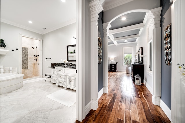 hall featuring hardwood / wood-style flooring, coffered ceiling, decorative columns, and ornamental molding