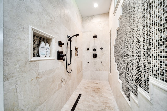 bathroom with tiled shower