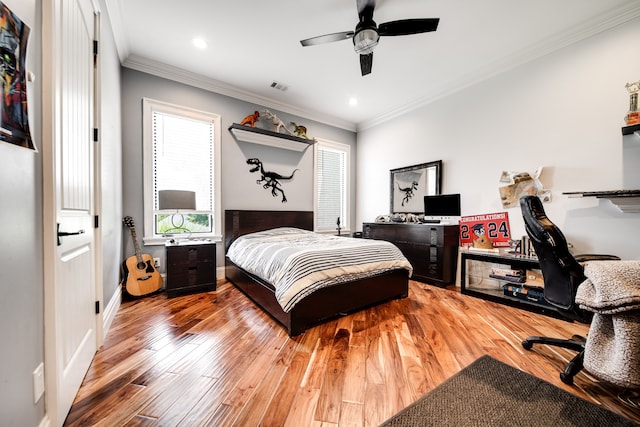 bedroom featuring ceiling fan, ornamental molding, and wood-type flooring