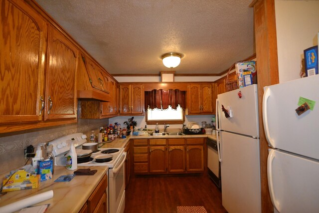 630 Marietta St, Pulaski, TN 38478 - kitchen featuring white appliances, a textured ceiling, brown cabinetry, dark wood finished floors, and light countertops