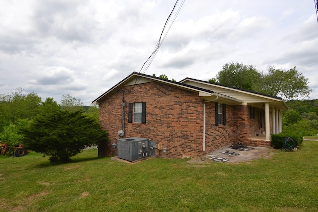 630 Marietta St, Pulaski, TN 38478 - view of home's exterior with brick siding and a lawn
