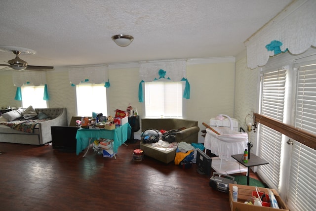 interior space with ceiling fan, wood-type flooring, and a textured ceiling