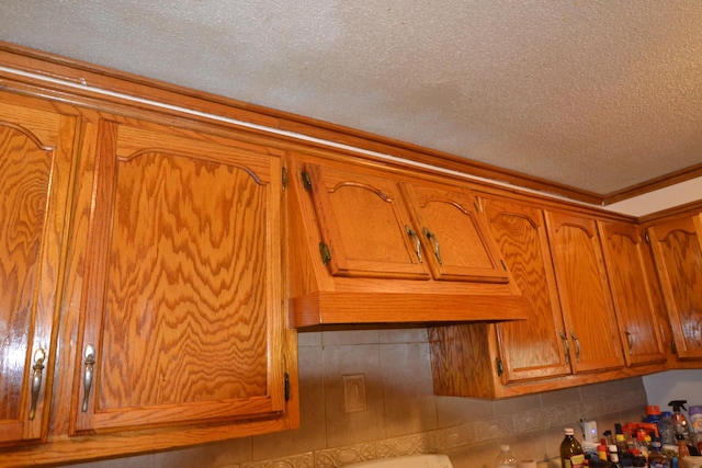 630 Marietta St, Pulaski, TN 38478 - kitchen view of brown cabinets, a textured ceiling, and ornamental molding