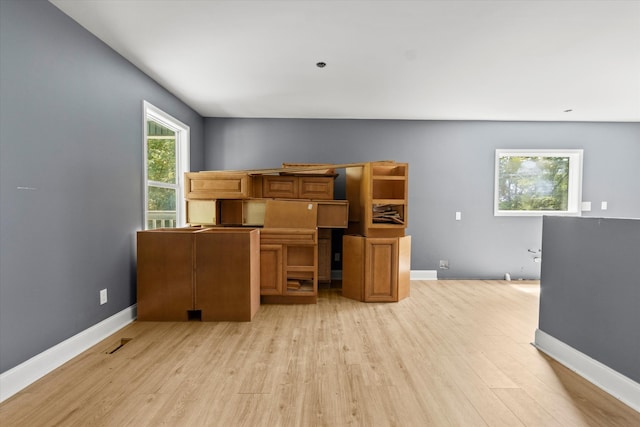 home office with light hardwood / wood-style floors