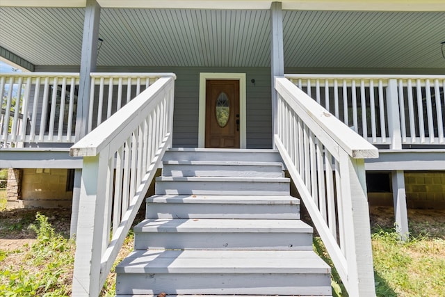 view of exterior entry with a wooden deck