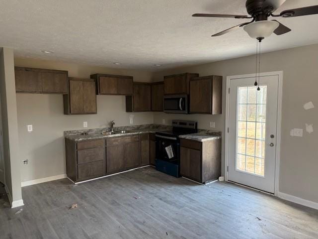 kitchen featuring sink, electric range, ceiling fan, and light hardwood / wood-style flooring