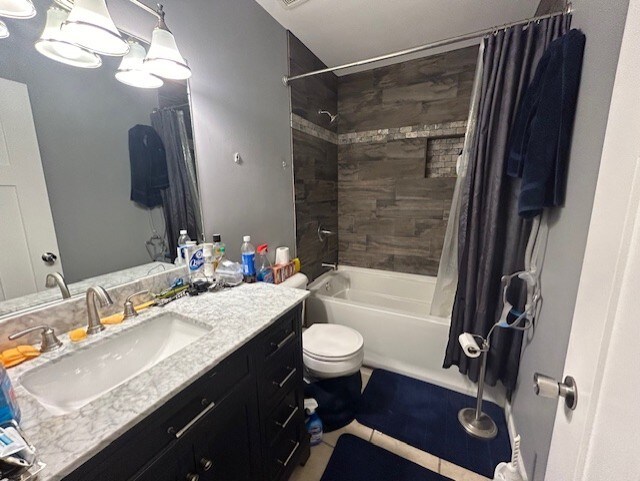 full bathroom with toilet, tile patterned flooring, shower / tub combo, and vanity