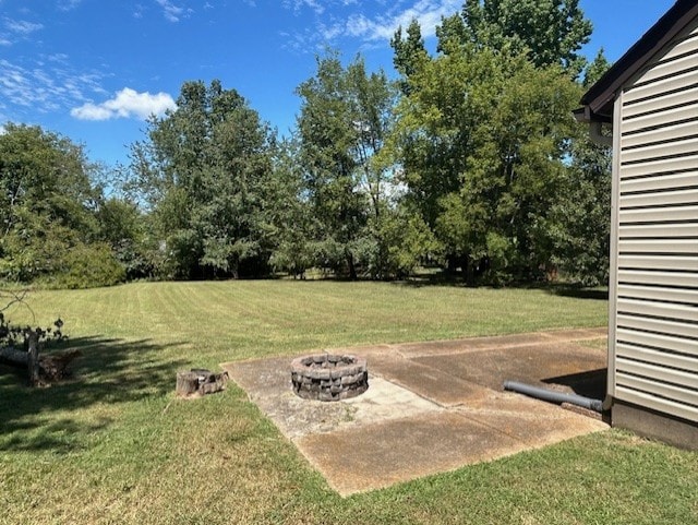 view of yard with an outdoor fire pit