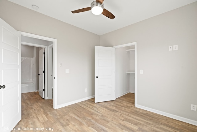 unfurnished bedroom with a closet, light hardwood / wood-style floors, and ceiling fan