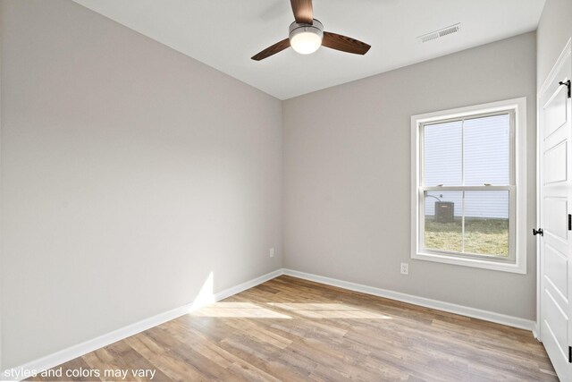 spare room featuring light hardwood / wood-style floors and ceiling fan