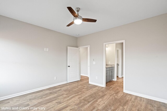 unfurnished bedroom with ceiling fan, ensuite bathroom, and light hardwood / wood-style floors