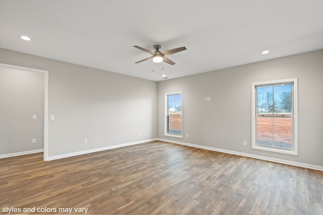 empty room with hardwood / wood-style floors and ceiling fan