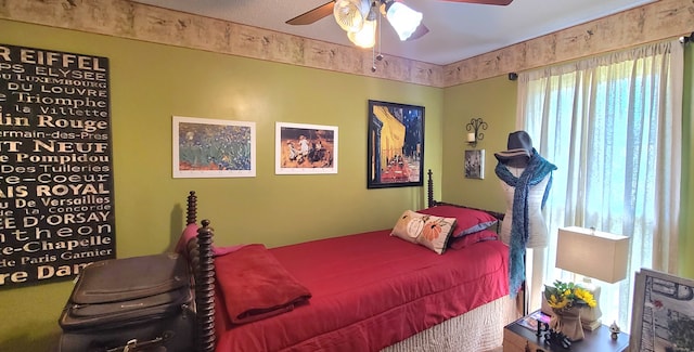 bedroom featuring ceiling fan and multiple windows