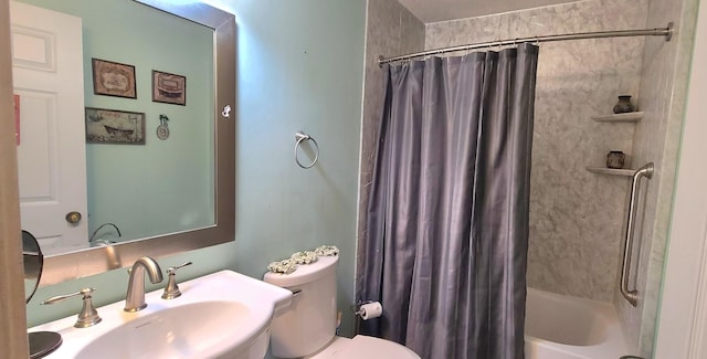 bathroom featuring toilet, shower / tub combo, and a sink