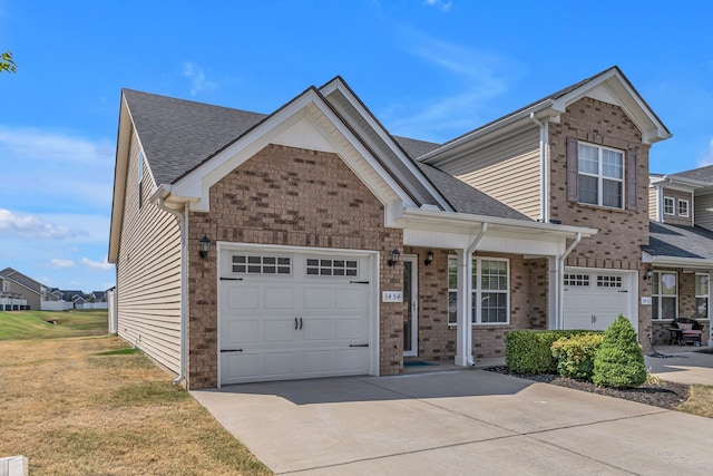 view of front of property featuring a garage and a front lawn