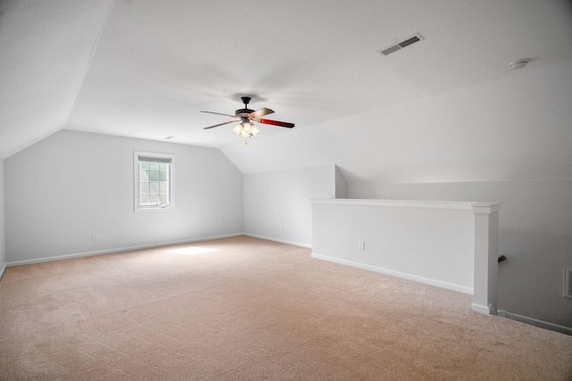 bonus room with lofted ceiling, light carpet, visible vents, and baseboards