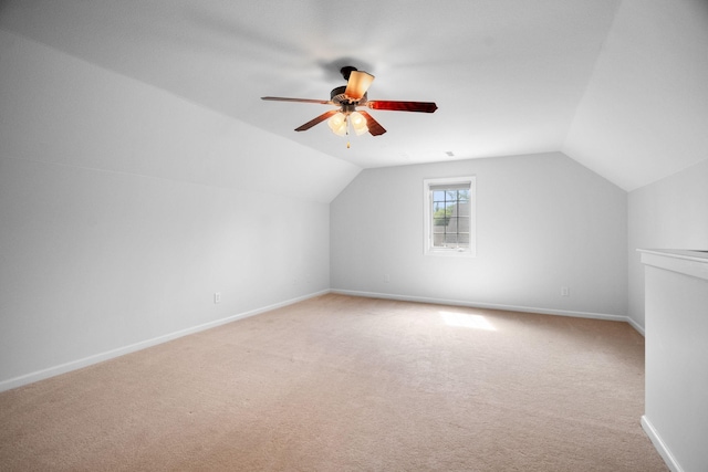 additional living space with vaulted ceiling, ceiling fan, carpet flooring, and baseboards