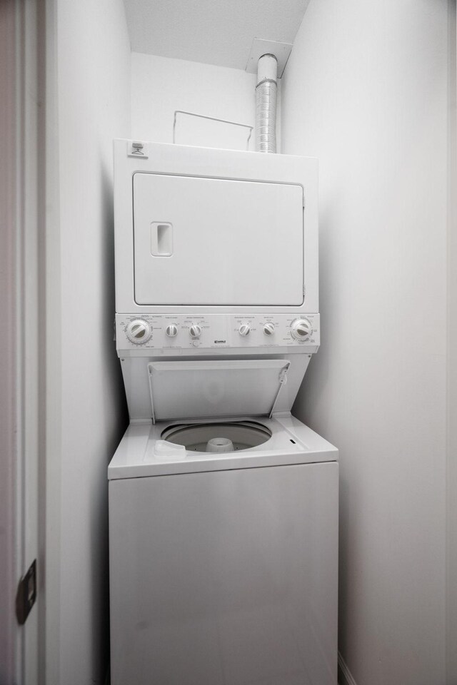 laundry area featuring stacked washer and dryer