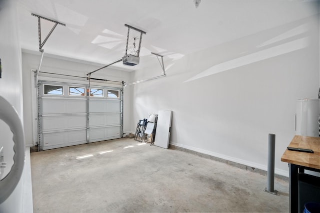 garage featuring a garage door opener and baseboards