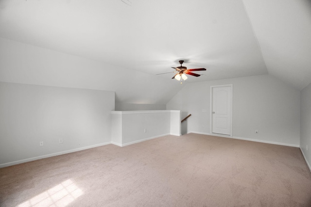 bonus room featuring a ceiling fan, baseboards, vaulted ceiling, and carpet flooring