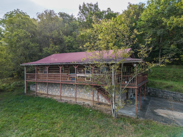 rear view of property with a lawn and a patio