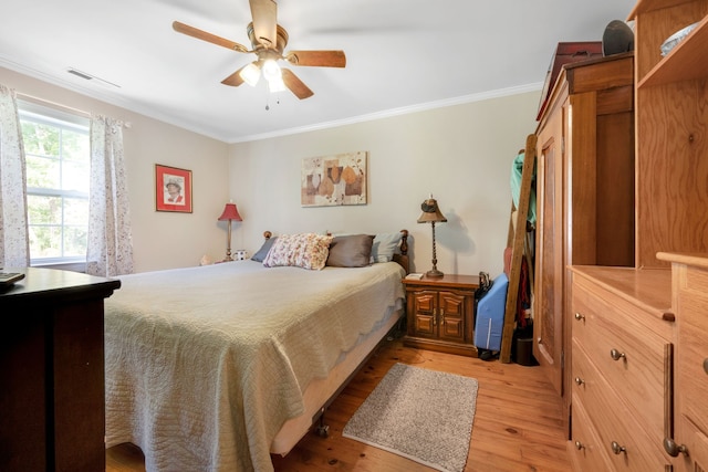 bedroom featuring light wood-type flooring, ceiling fan, and crown molding