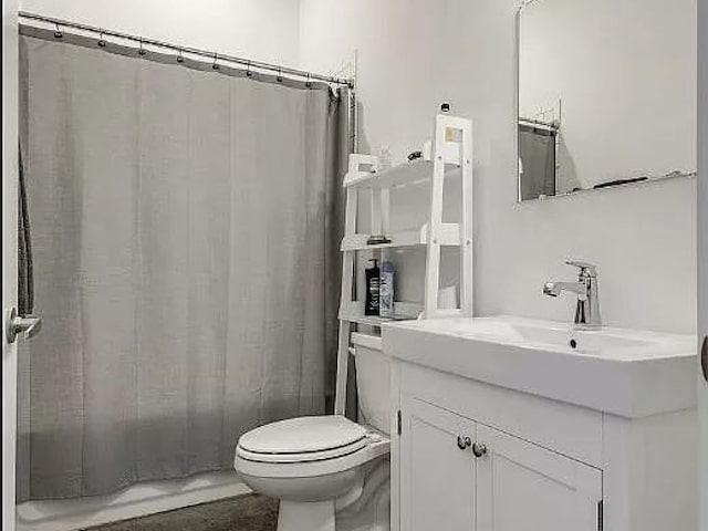 bathroom with toilet and vanity