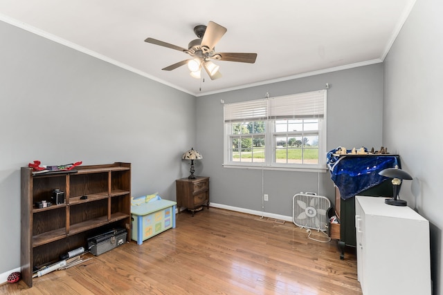 misc room with ceiling fan, light hardwood / wood-style flooring, and ornamental molding