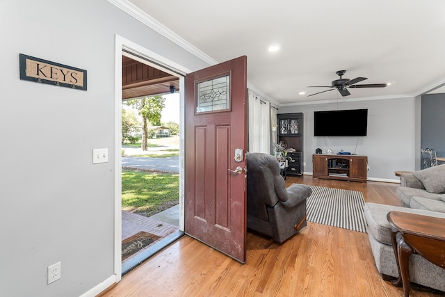 entrance foyer featuring ceiling fan, hardwood / wood-style floors, and crown molding