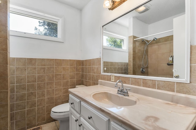 bathroom featuring tile walls, tile patterned flooring, vanity, and toilet