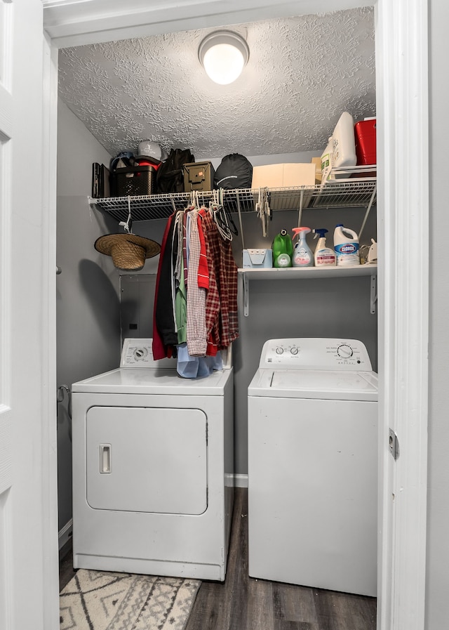 laundry room featuring a textured ceiling, hardwood / wood-style flooring, and separate washer and dryer