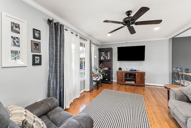 living room with ceiling fan, ornamental molding, and hardwood / wood-style flooring