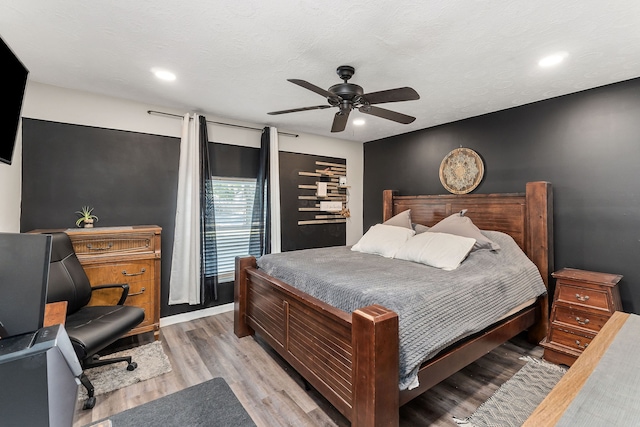 bedroom with ceiling fan and light hardwood / wood-style flooring