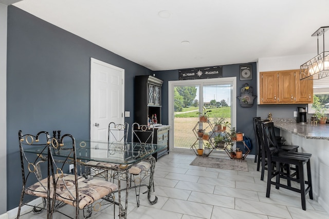 dining room featuring a wealth of natural light and light tile patterned floors